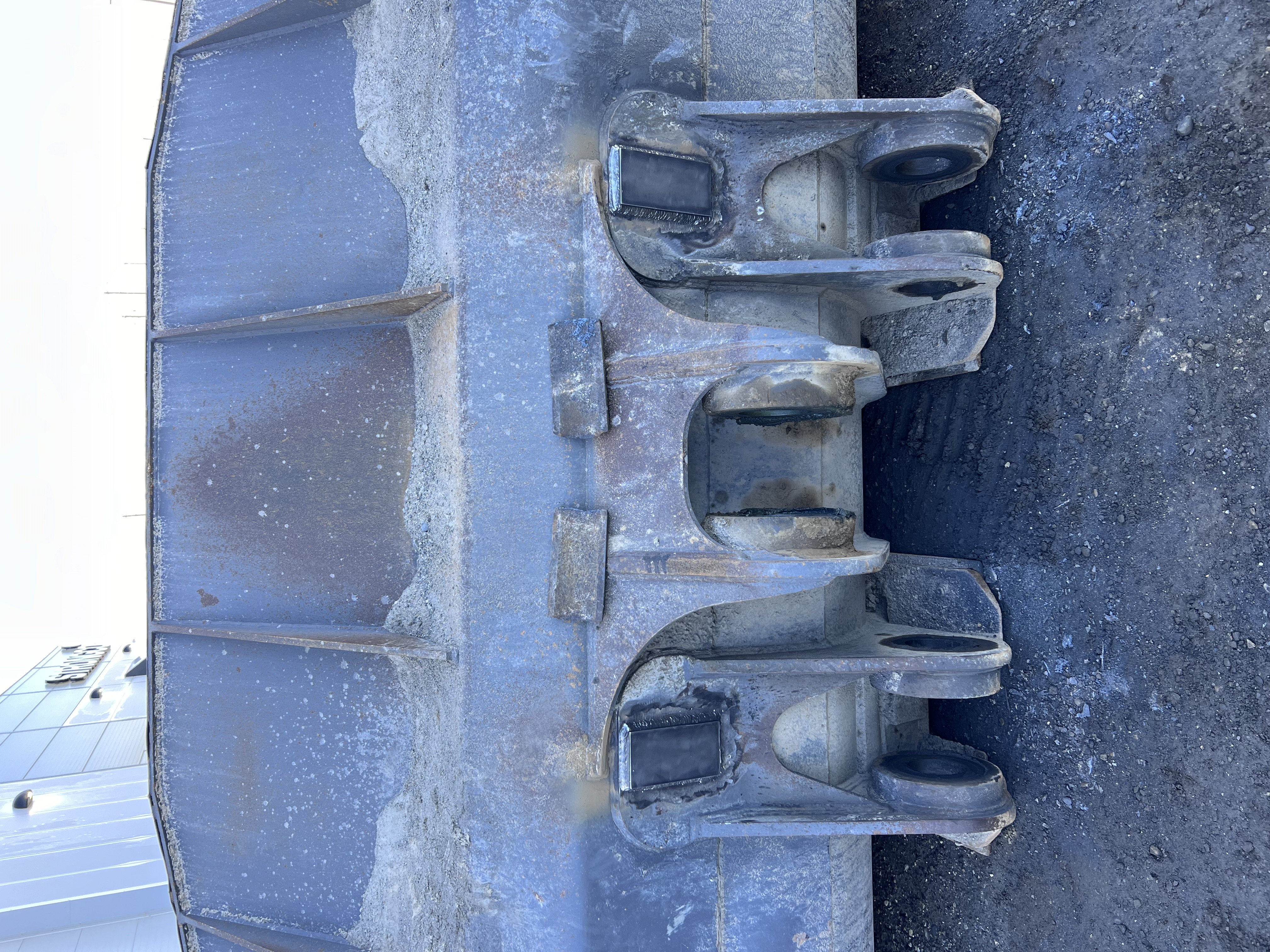 Close-up of a heavy cast metal component, possibly a machine counterweight or base.