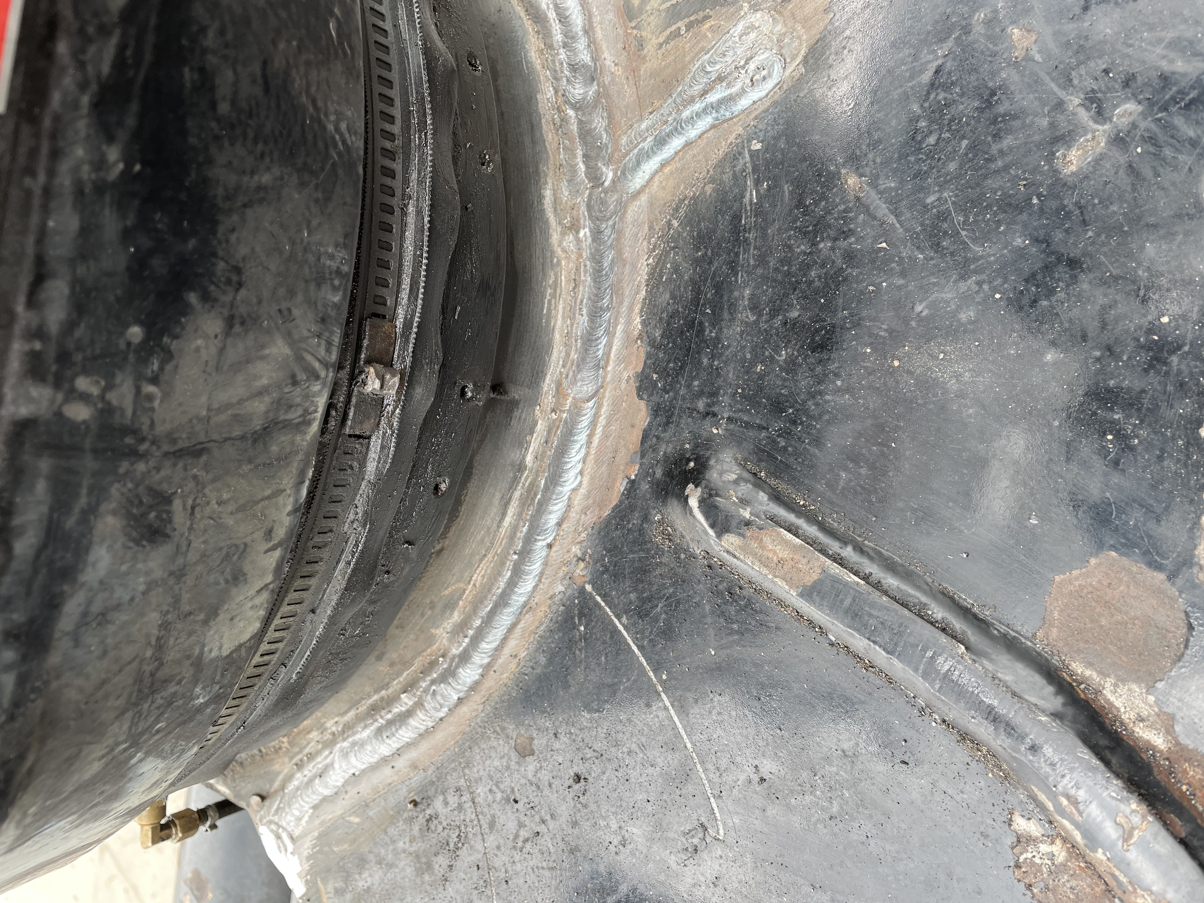 Close-up showing a weld bead inside the end of a circular metal piece or pipe.